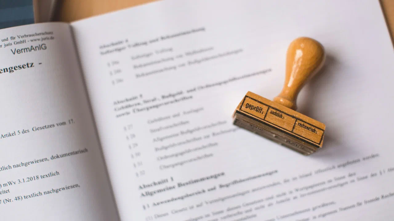 A wooden rubber stamp resting on an open printed legal document