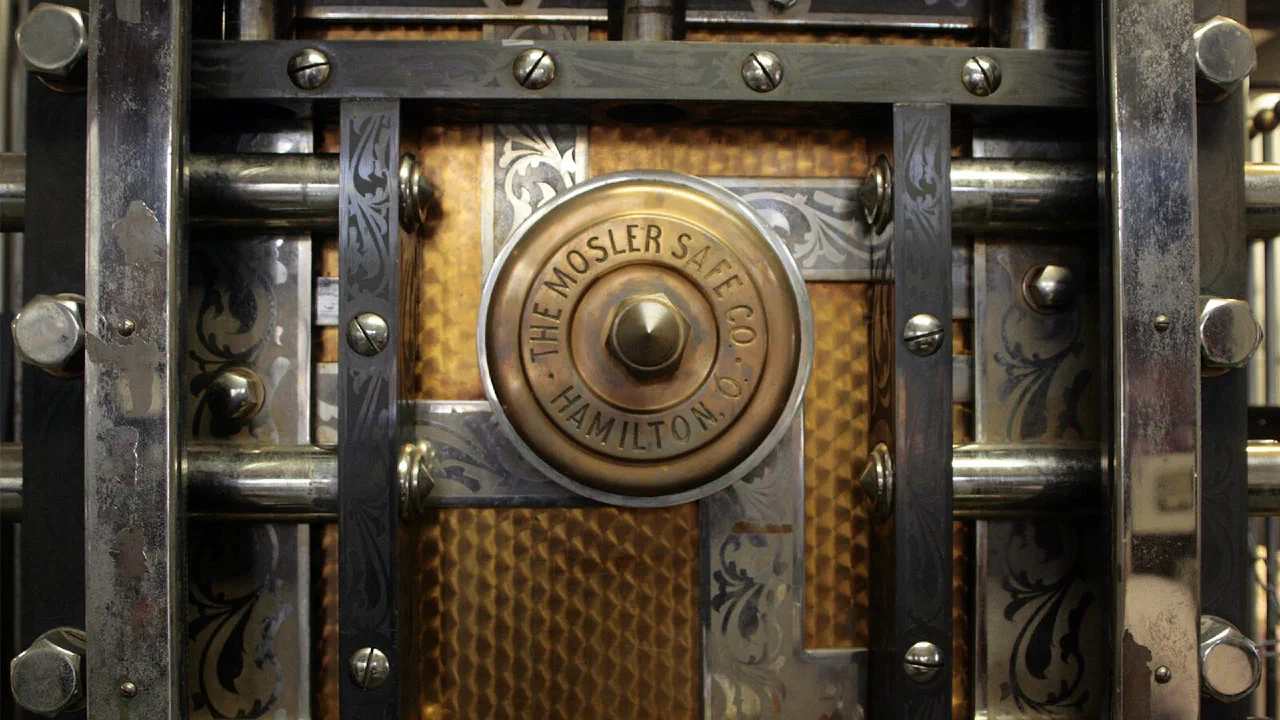 A close-up of a heavy metal door fitted with a combination lock