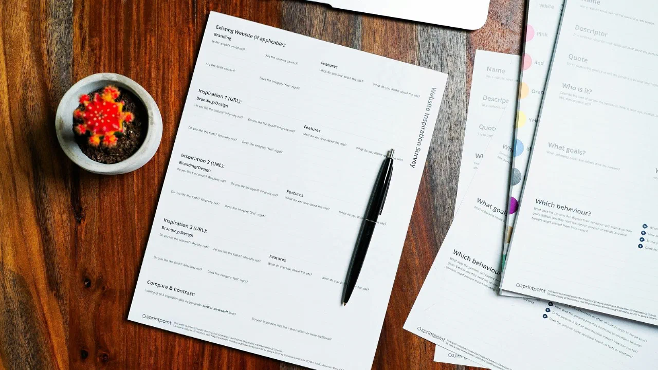 Papers and a pen on a wooden table